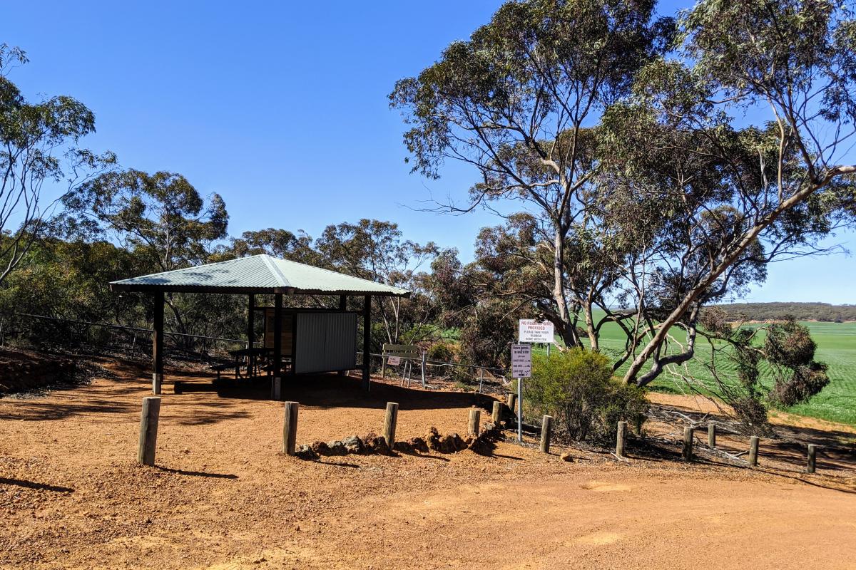 Shade shelter with picnic benches and information signs next to the carpark at the Mount Matilda Walk Entrance