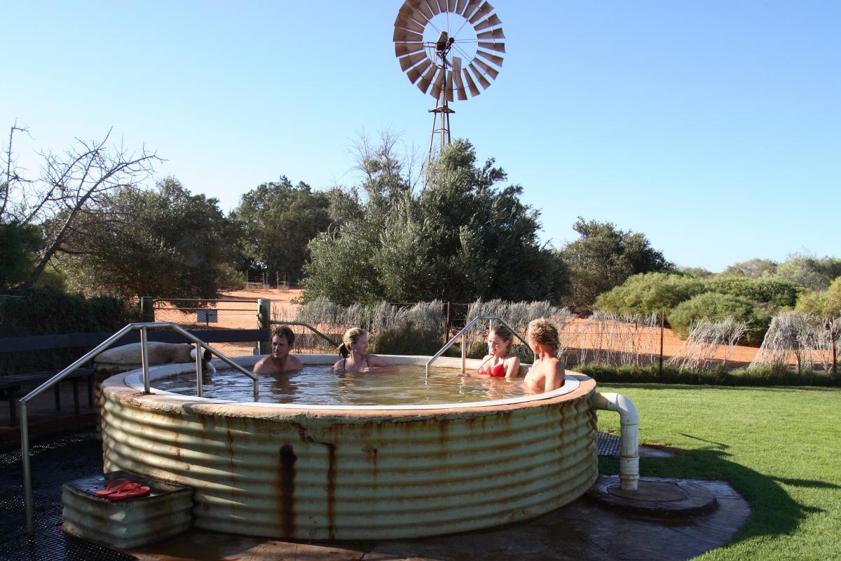 People swimming in the hot tub at Peron Homestead