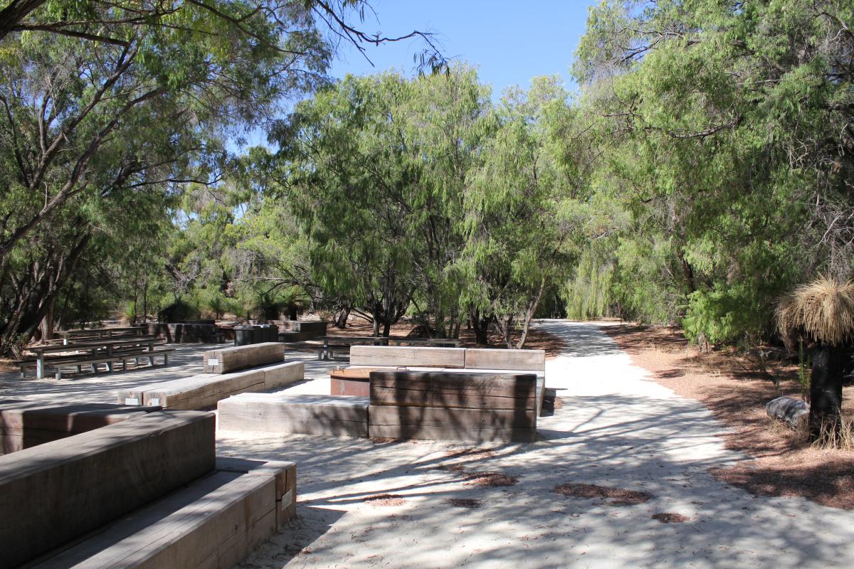 social bench seating in a picnic area with bbq facilities and fire pit