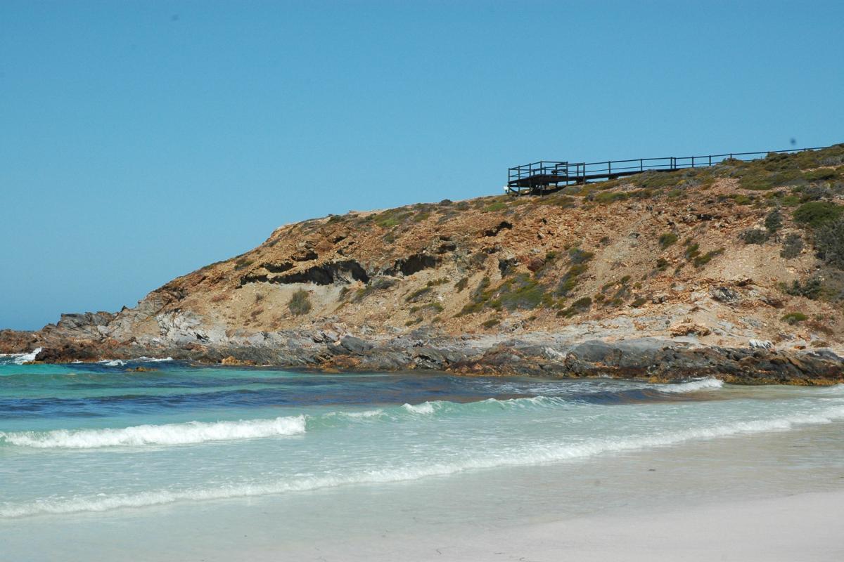 looking up at a rugged cliff with a visitor viewing platform on top at Point Ann