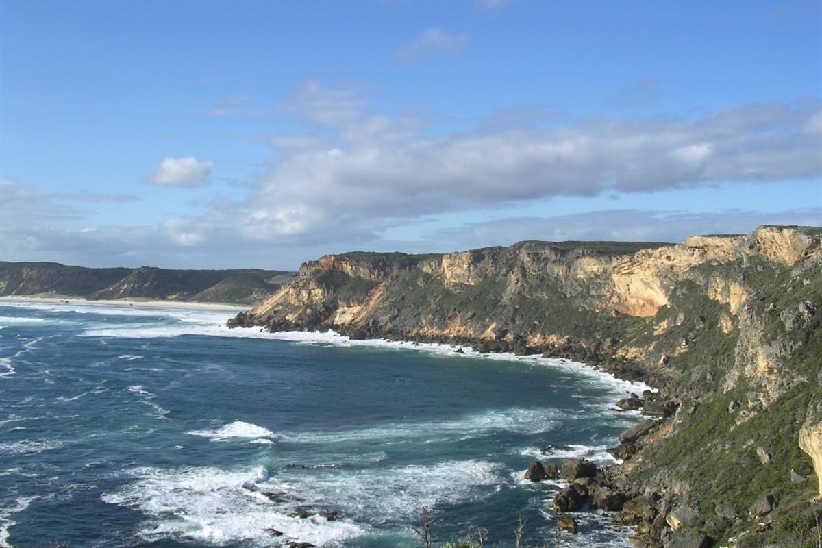 Limestone cliff tops towering over the blue ocean