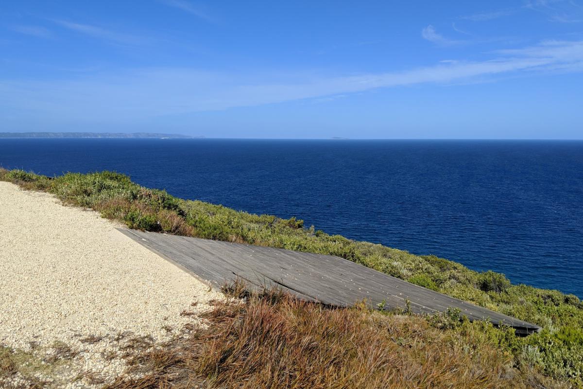 The ramp at Shelley Beach lookout where paragliders launch, with the blue ocean in the background on a blue-sky sunny day