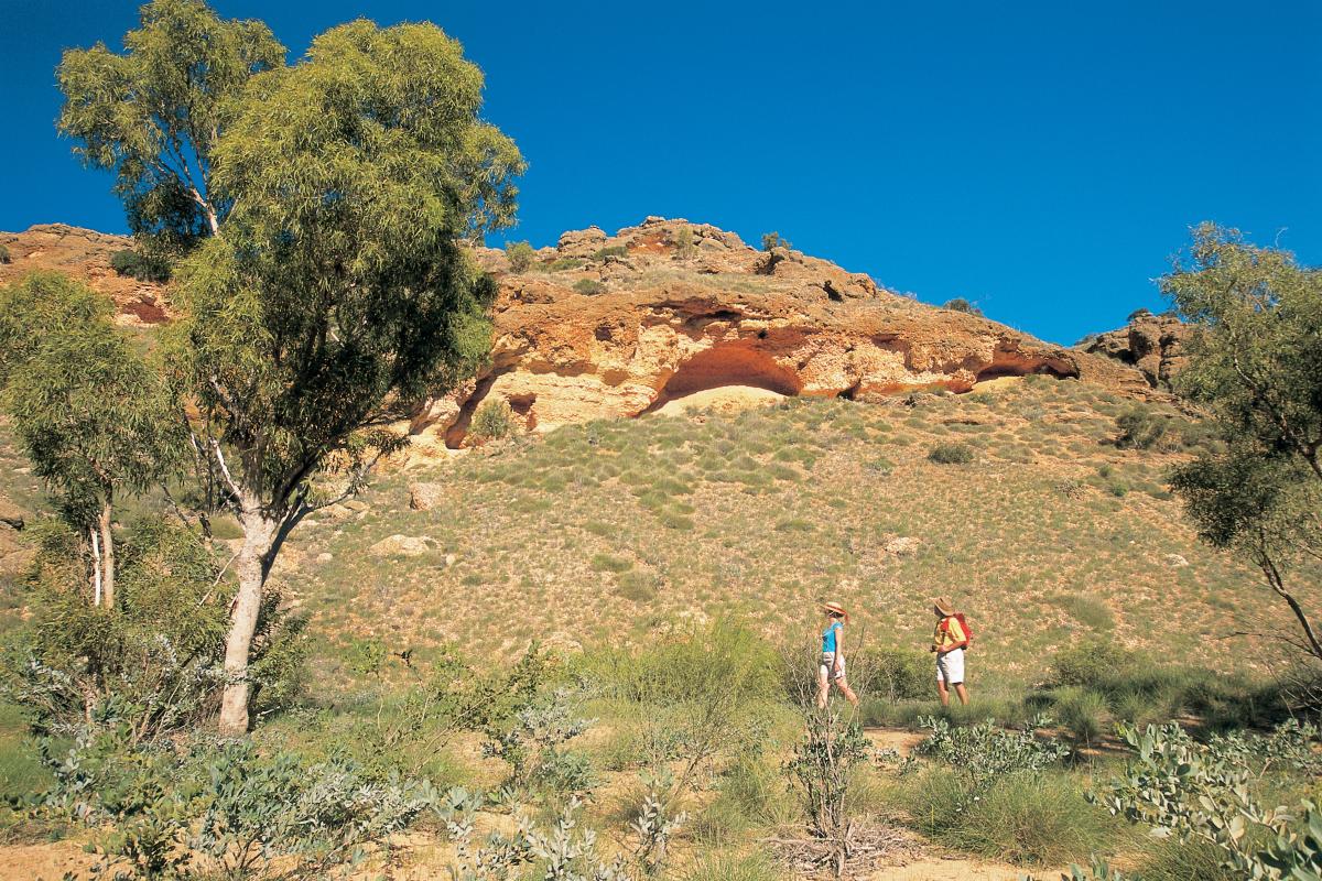 Two people walking in a canyon