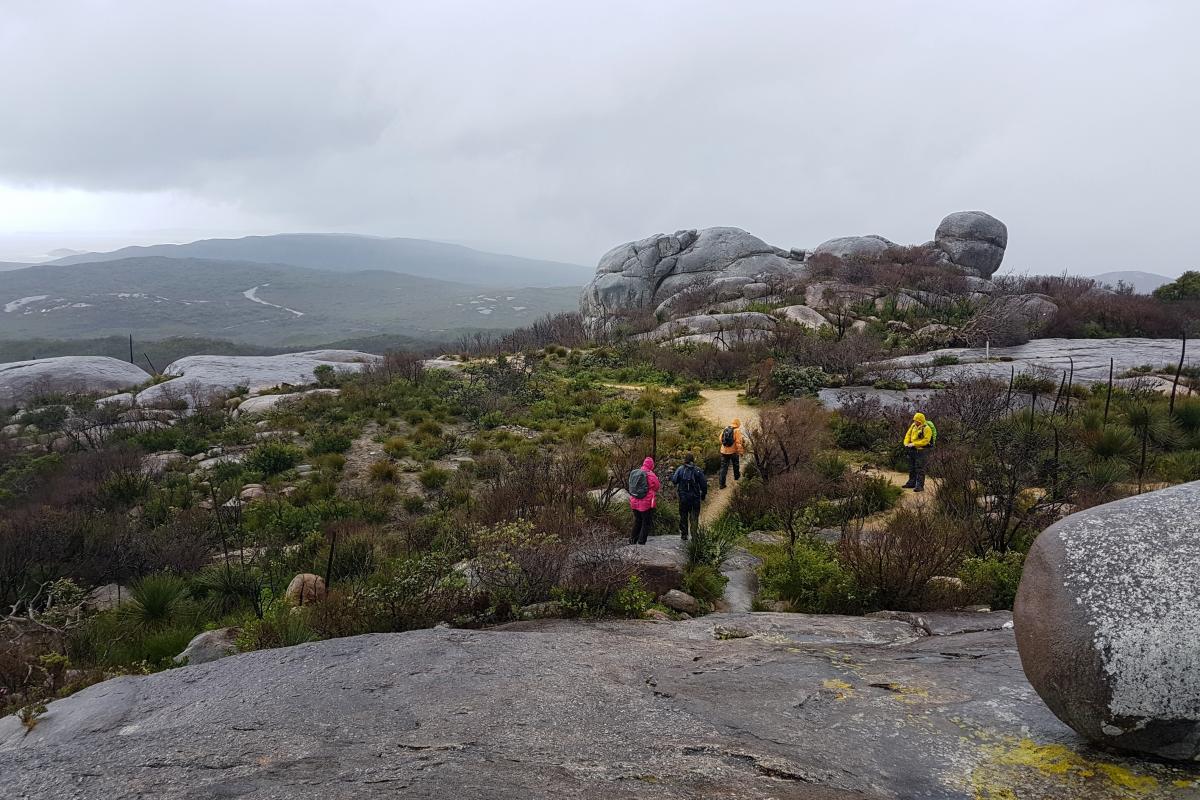 Stony Hill on a bleak and stormy Makuru day People walking on the Stony Hills path on a stormy winter's day