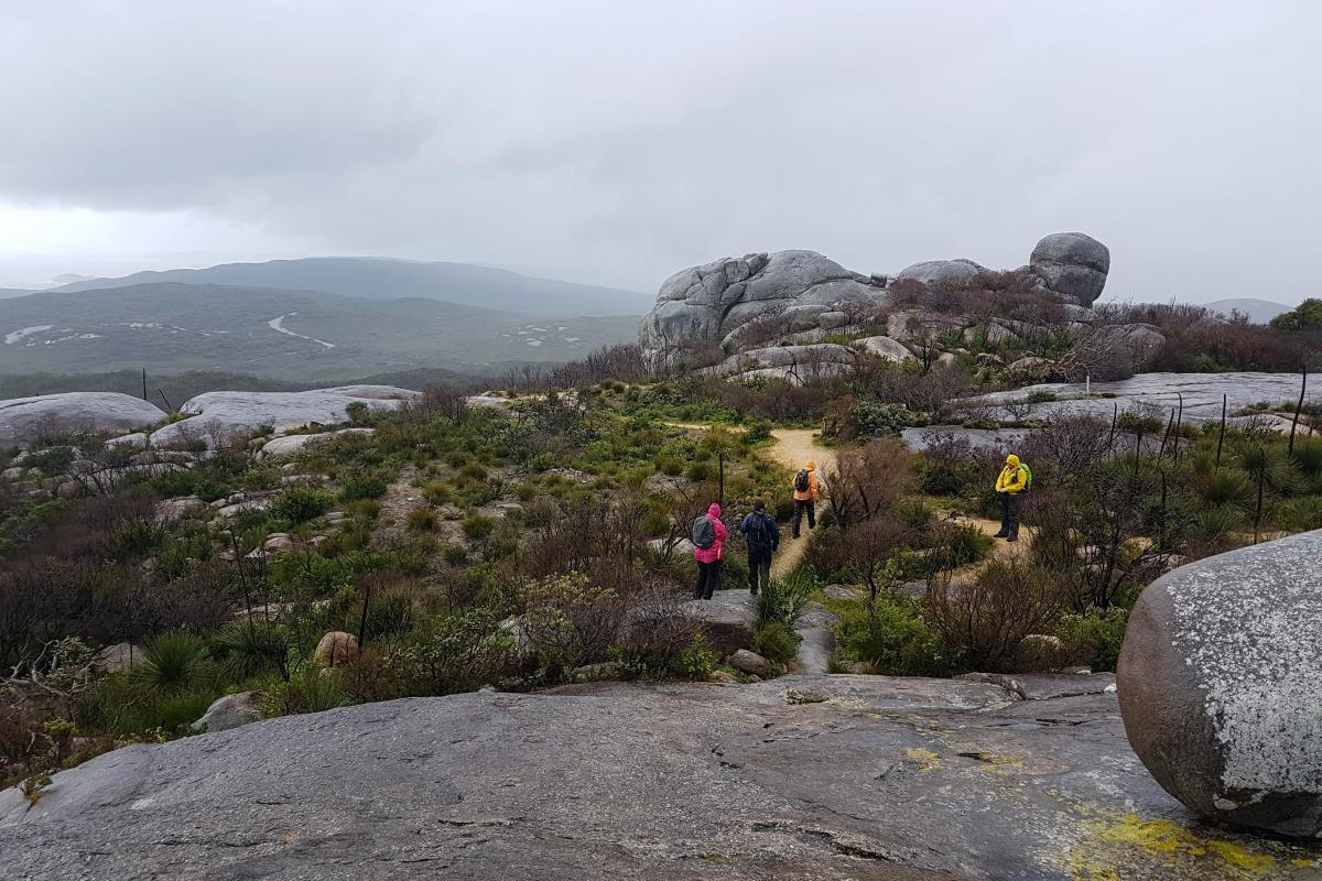 People walking on the Stony Hills path on a stormy winter's day