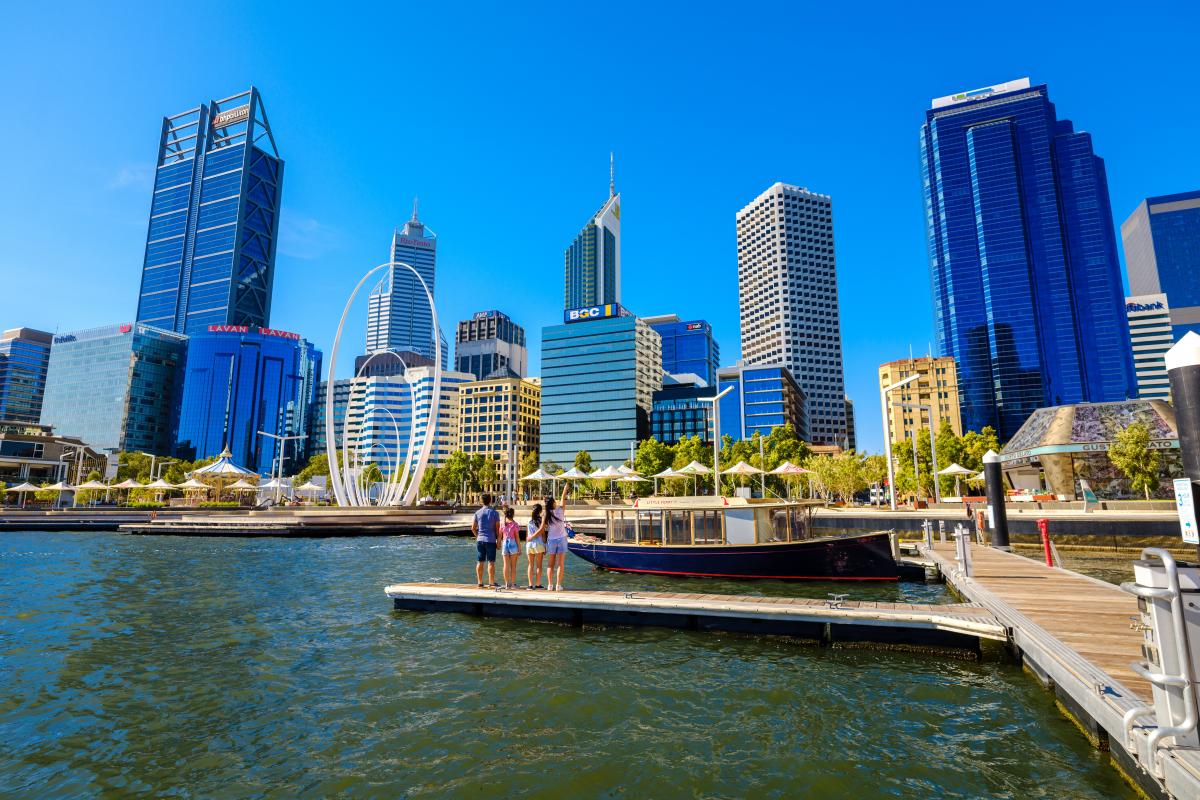 People standing on the jetty at Elizabeth Quay with tall buildings in the background