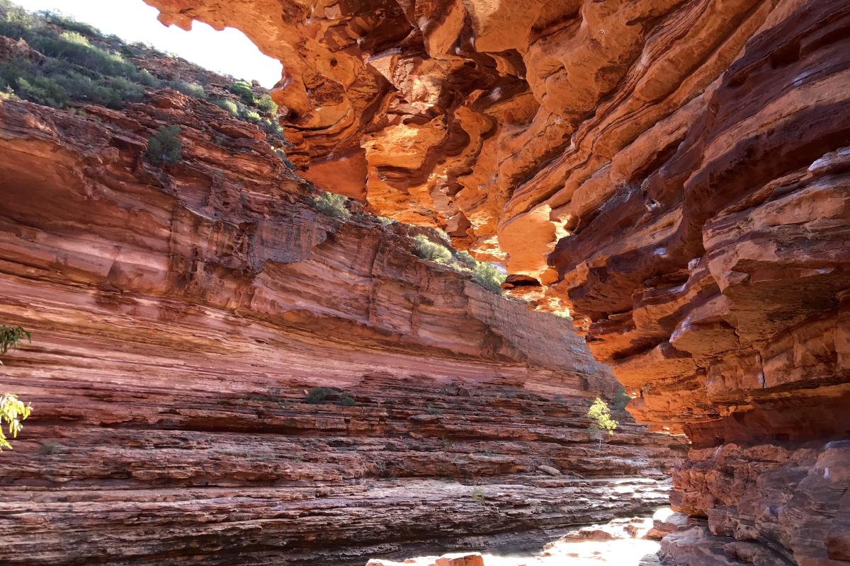 sunlight glinting over banded layers of sandstone rock in Kalbarri National Park