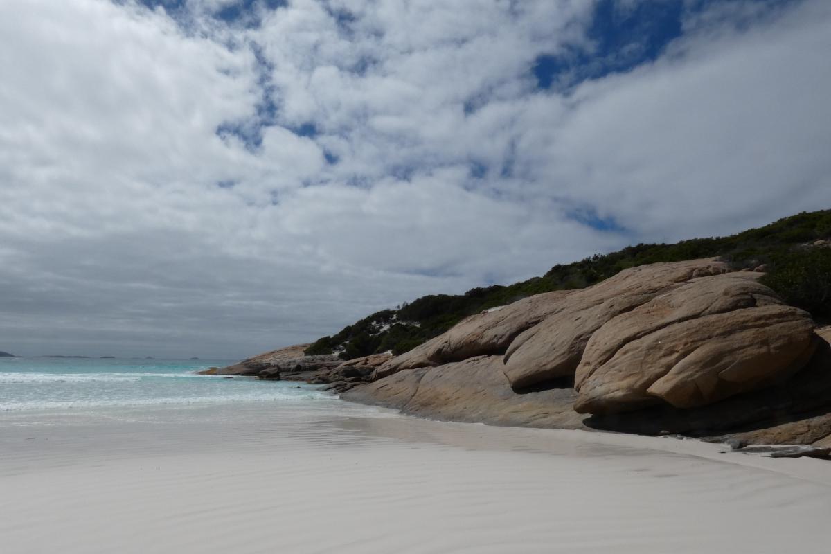 sandy beach beside weathered smooth rocks at Dunn Rocks