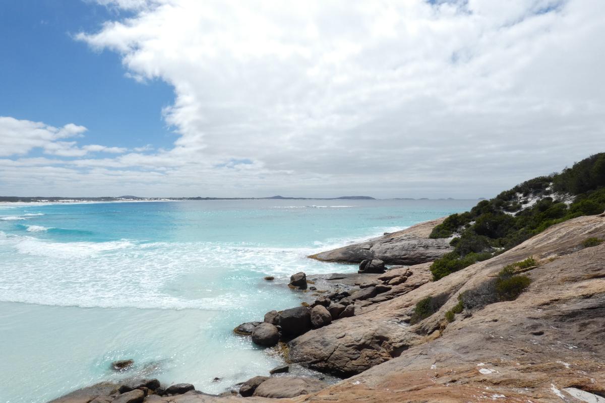 weathered smooth rocks sloping down to a turquoise ocean at Dunn Rocks