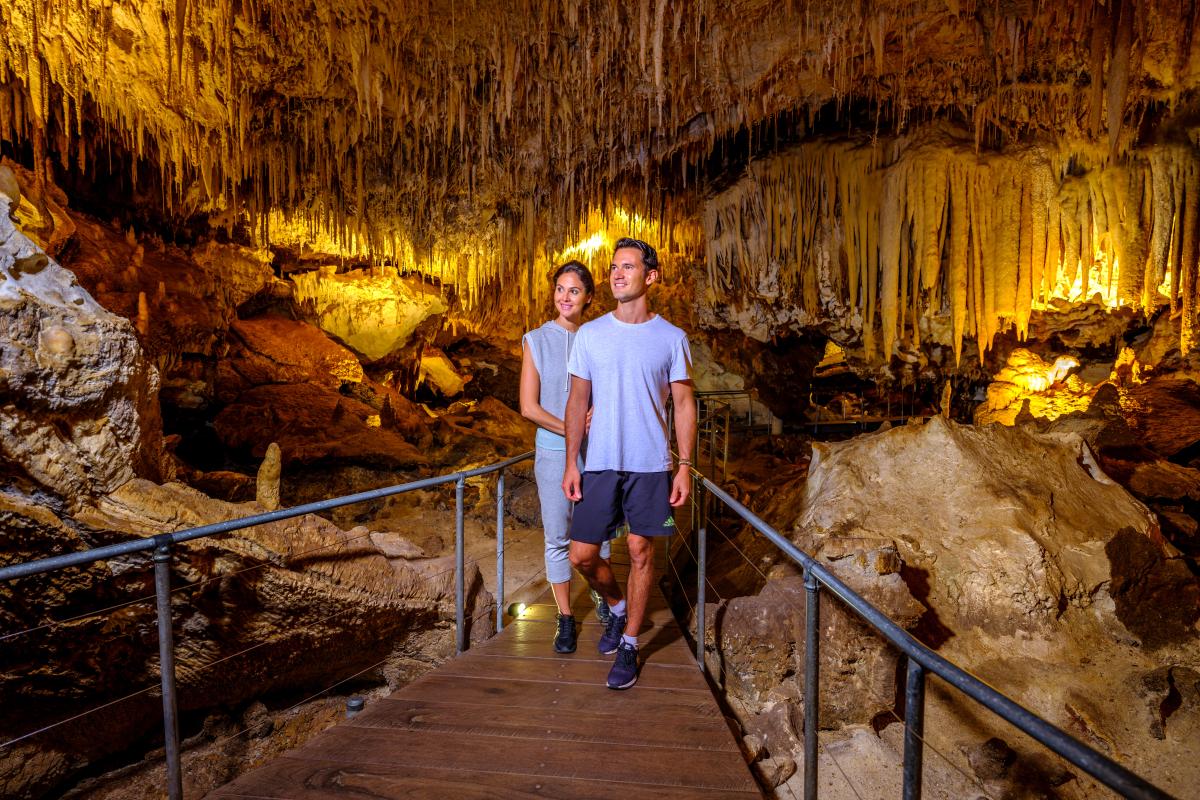 Couple walking though Jewel Cave. 