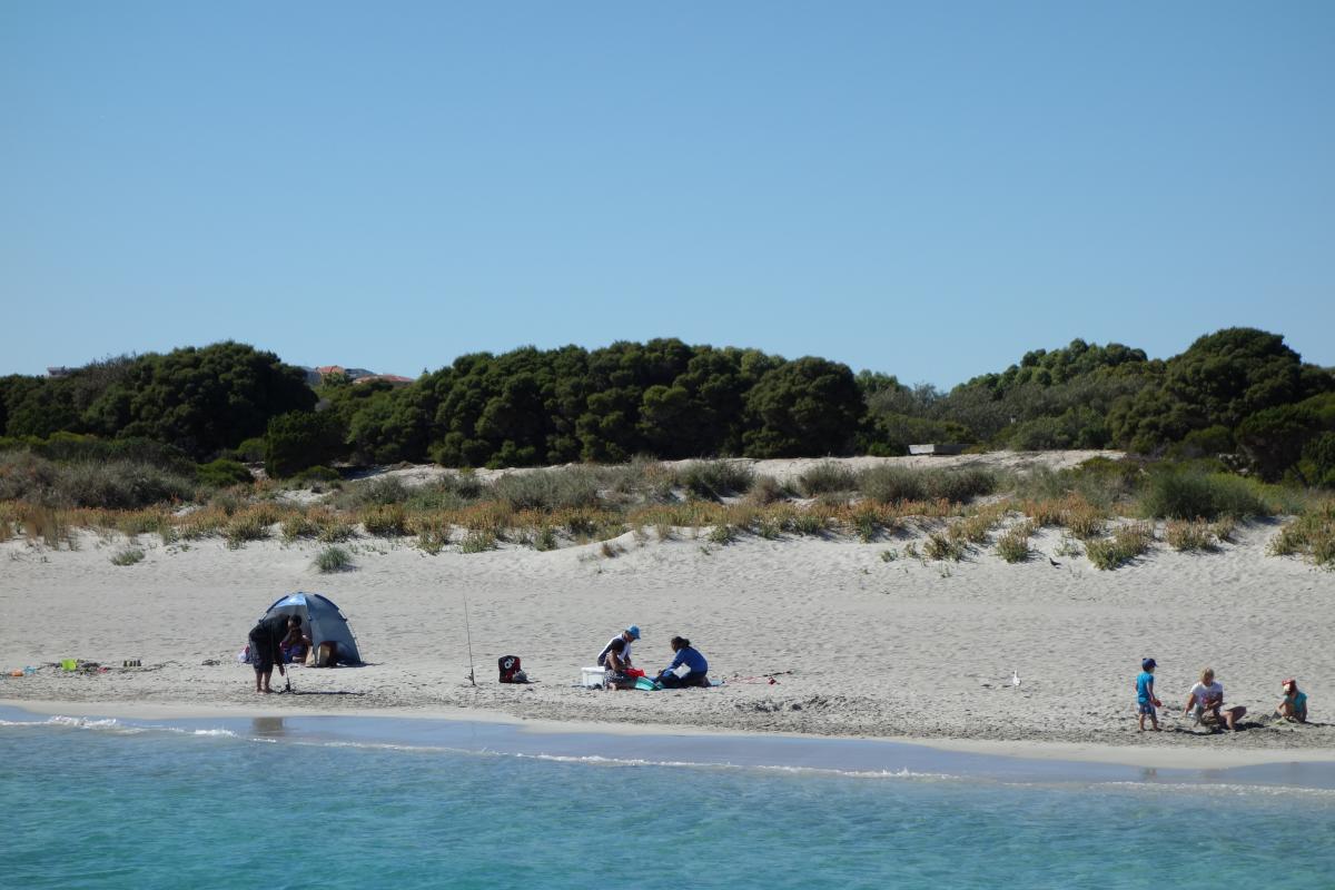 People enjoying a calm and sunny morning at the beach near John Graham Reserve at Woodman Point.
