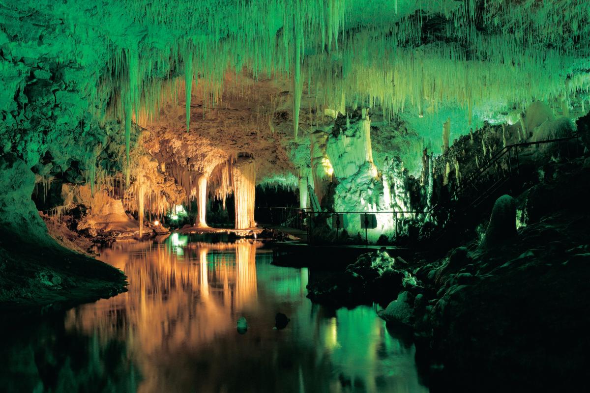 Colourful lights on the walls of Lake Cave