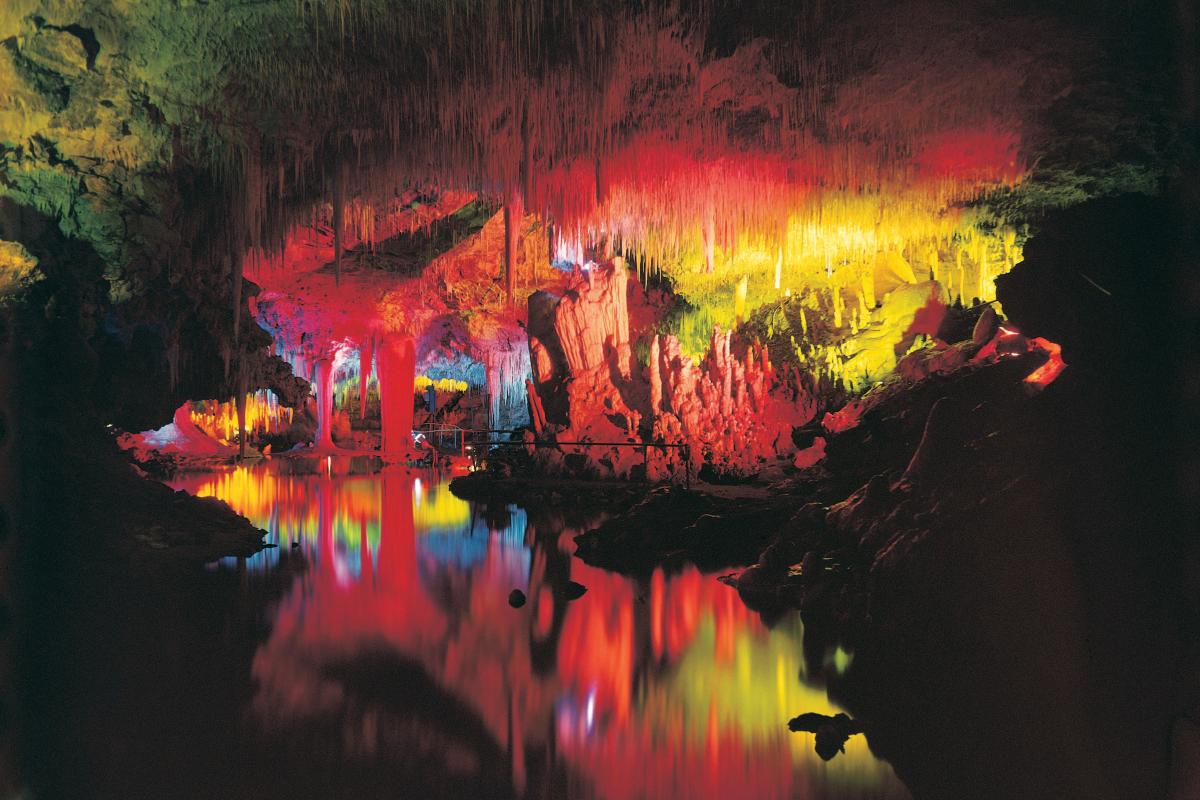 Colourful lights on the walls of Lake Cave
