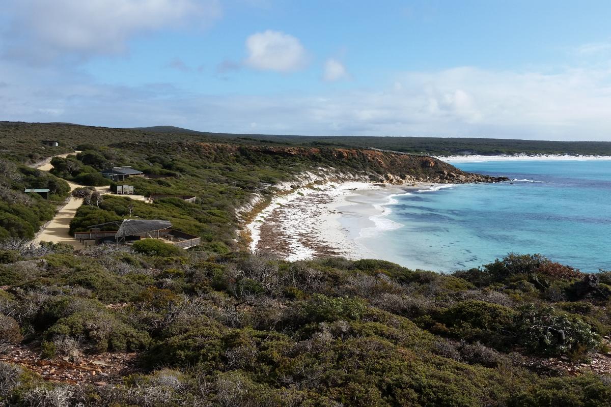 Calm water, white sand beach, and picnic facilities at Point Ann