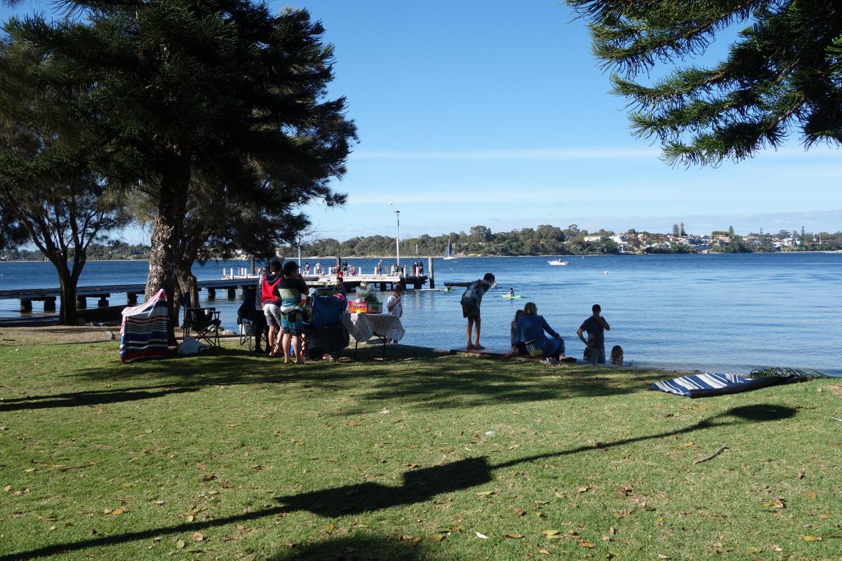 The grassed picnic area extends to the water's edge near the jetty at Point Walter.