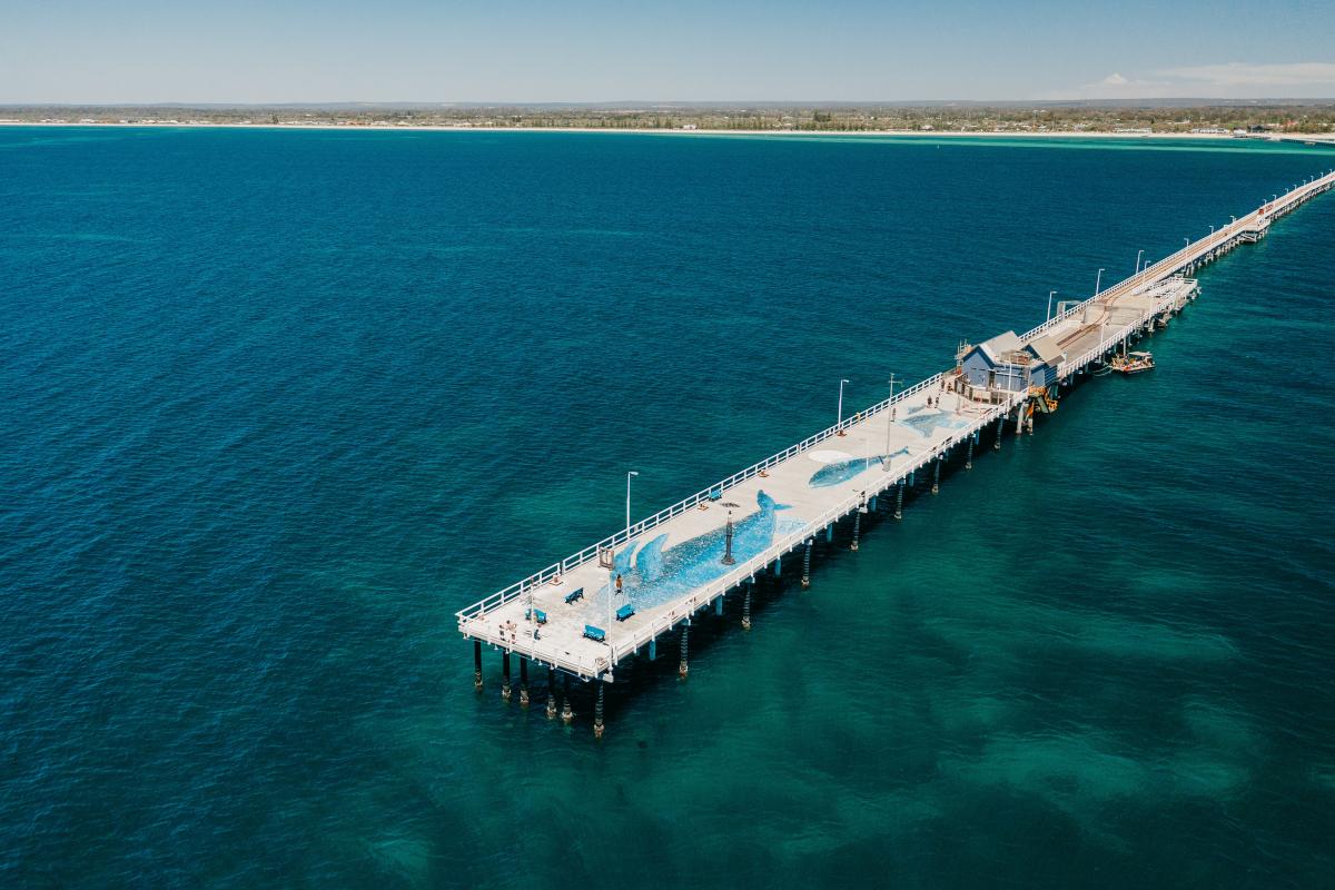 Aerial view of the end of Busselton Jetty with whales painted on the jetty