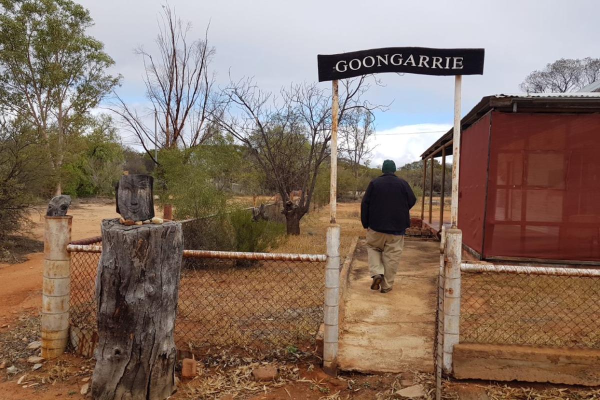 Man walking around Goongarrie Homestead