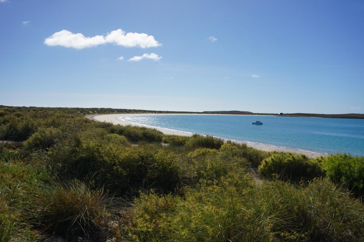 boat anchored in a bay at Rosemary Island