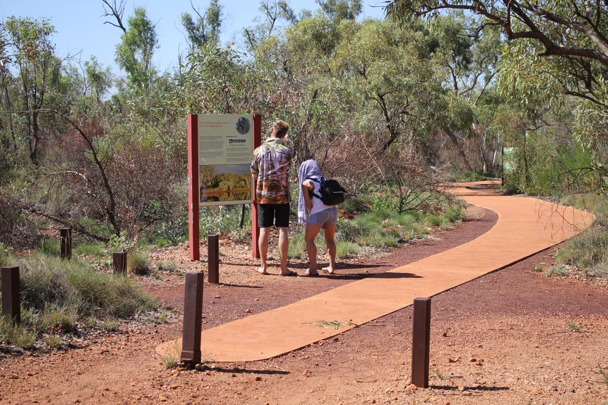 two people reading the sign beside the path that leads to deep reach pool