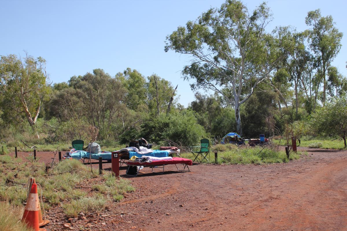 camp beds and fold up chairs in a camp site at miliyanha campground