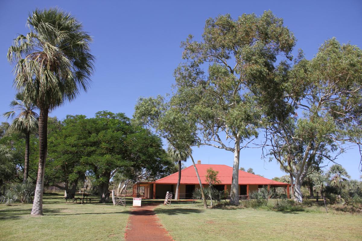 Millstream homestead surrounded by green lawns and shady trees