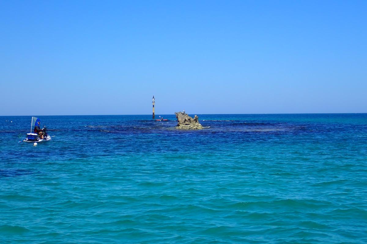 Water activities in the blue ocean reef of Cow Rocks