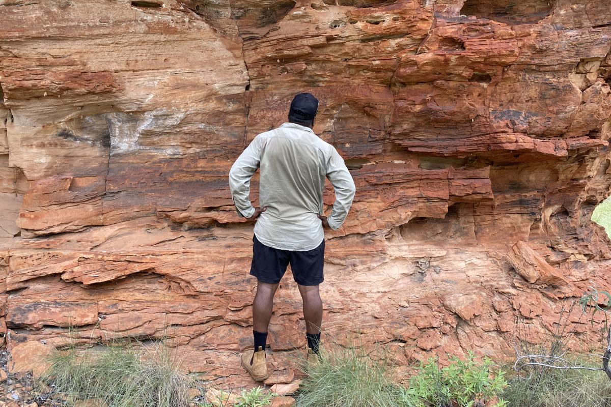 Ranger checking artsite 2 on the Rock Art Trail Ranger looking at artsite two on the trail