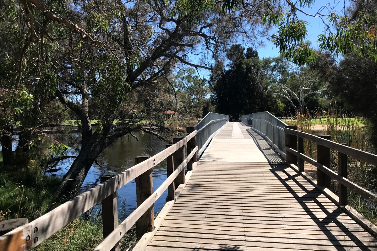 Wooden boardwalk leading onto the accessible footbridge at Kent Street Weir