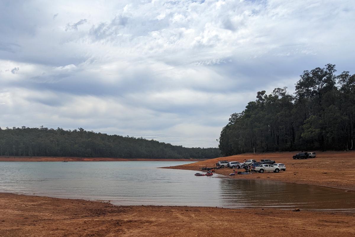 vehicles parked on the banks of Lake Navarino