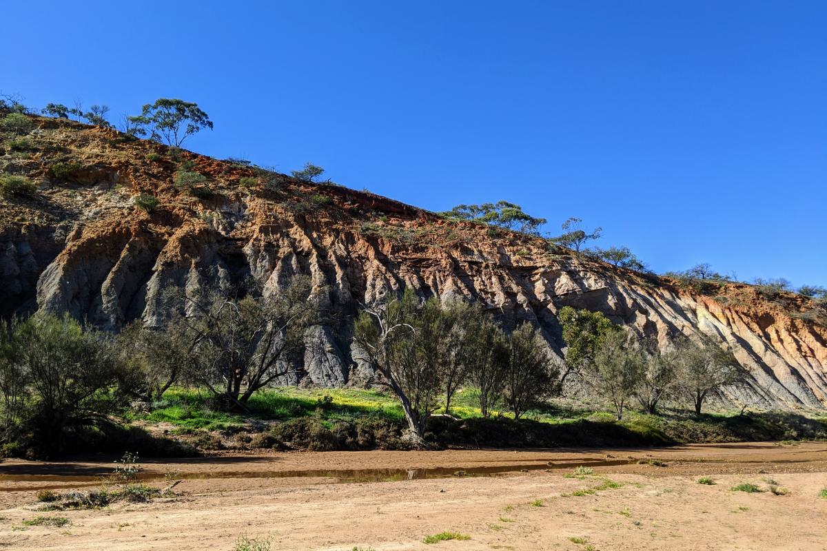 Riverbend with layers of soil types visible in the wall if the range