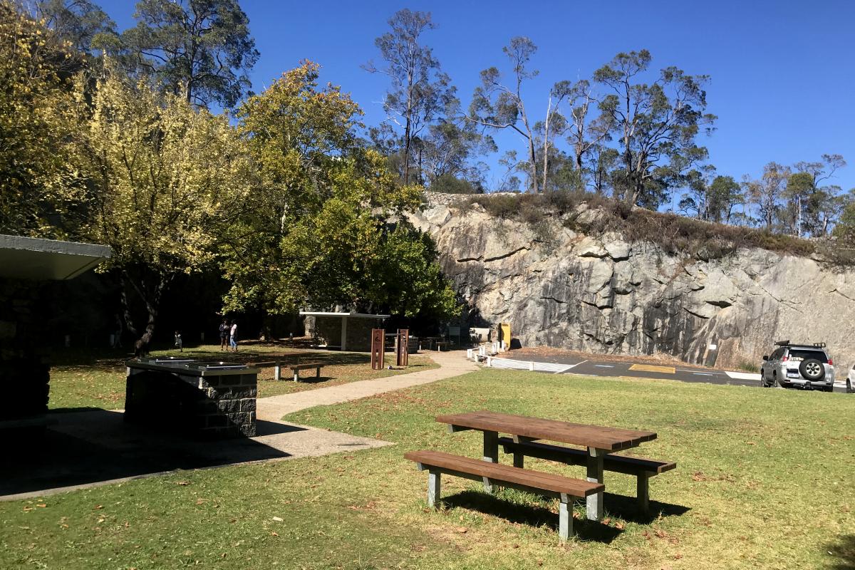 grassy picnic area with picnic tables at The Quarry