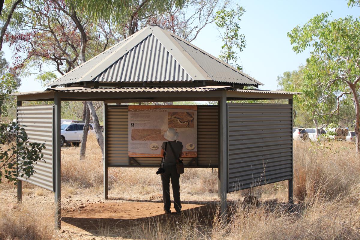 A person reading the signs in the shelter before starting the walk to Dalmanyi Gorge