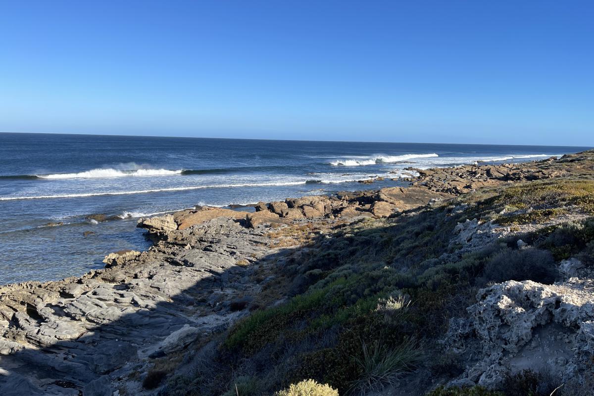 View of rocks leading down to the ocean.