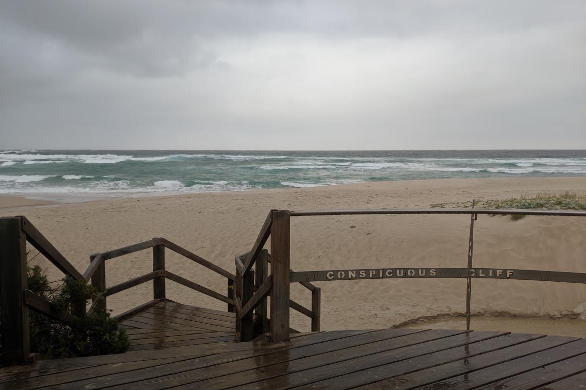 Steps down to the sand at Conspicuous Beach