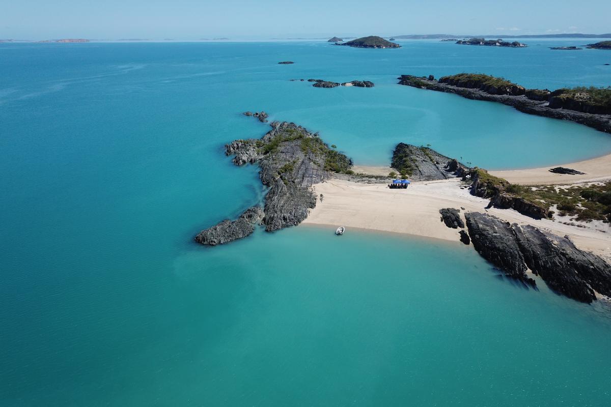 Edeline Island Aerial view of islands surrounded by green ocean.