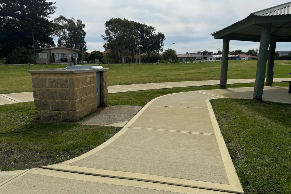 BBQ and a shetered picnic bench linked by accessible pathways BBQ and a shetered picnic bench linked by accessible pathways