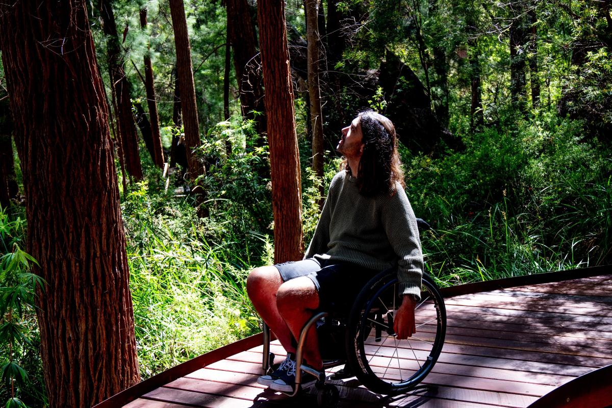 Person in wheelchair on boardwalk. 