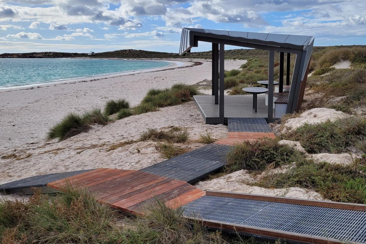 Houtman Abrolhos Islands National Park Wooden shelter and boardwalk leading down to the beach.