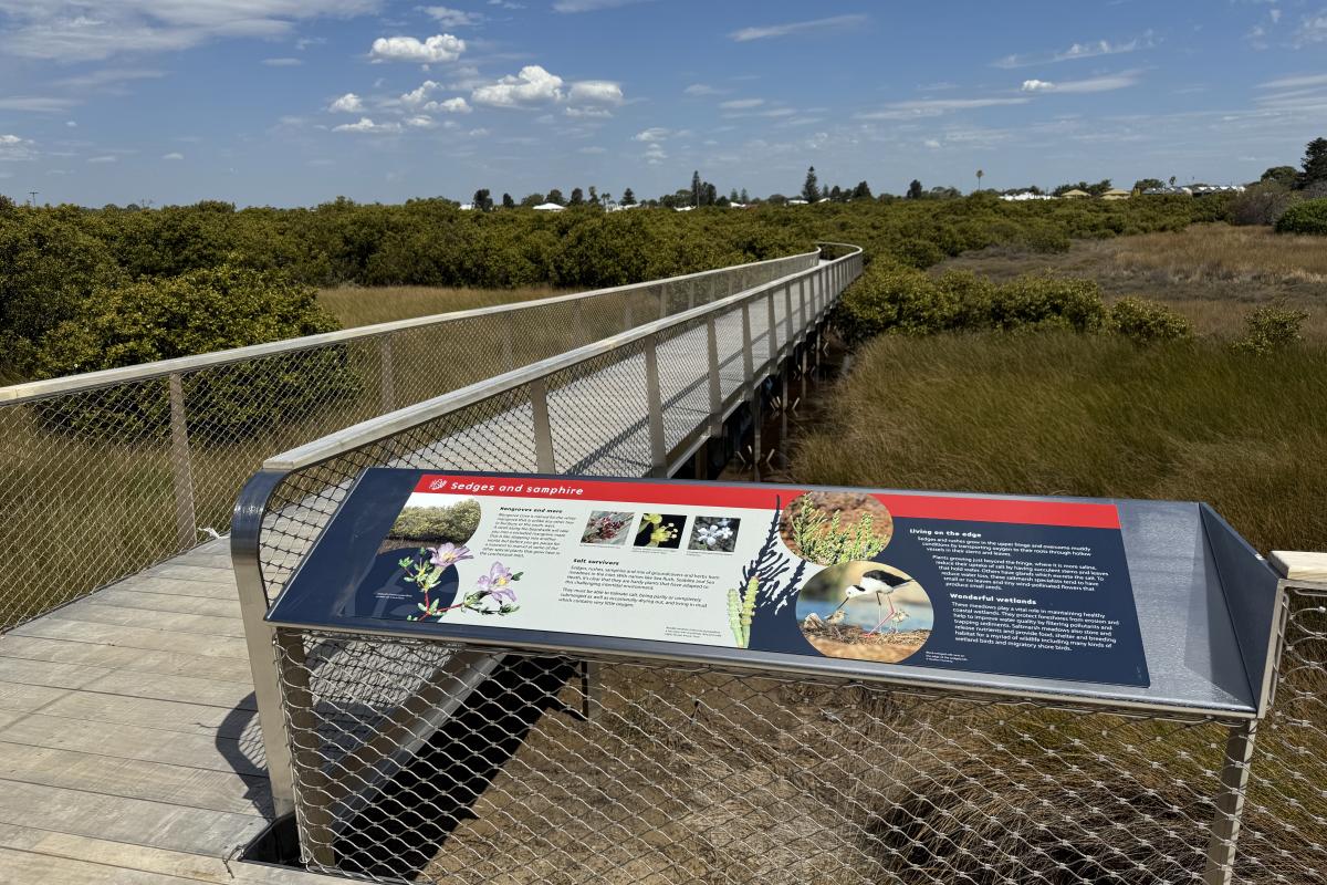 Signage at the start of a boardwalk. 