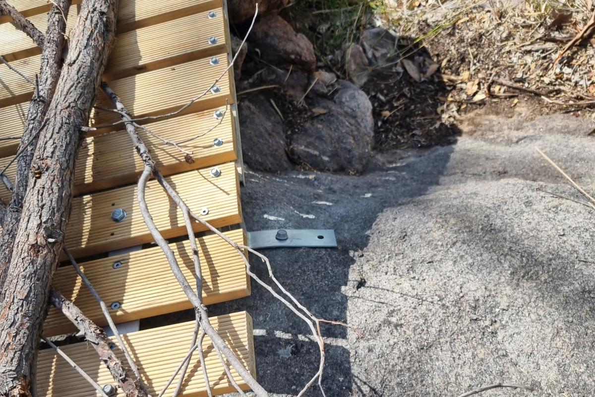 Closure of illegally built trails Metal screws and plates drilled into granite to make a bridge.