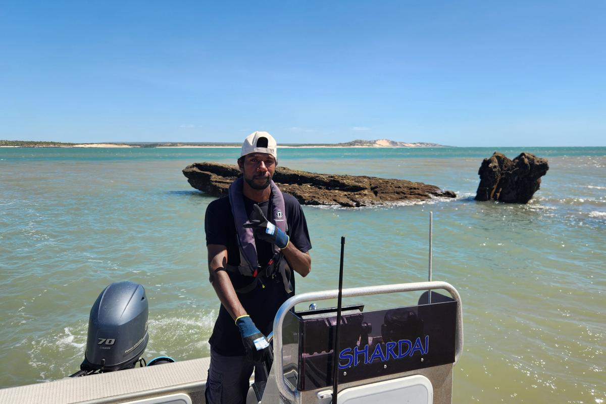 Person driving a small boat. 