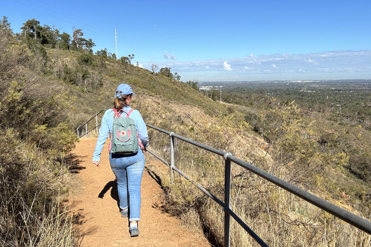 Lesmurdie Falls Person weating backpack walking on path.
