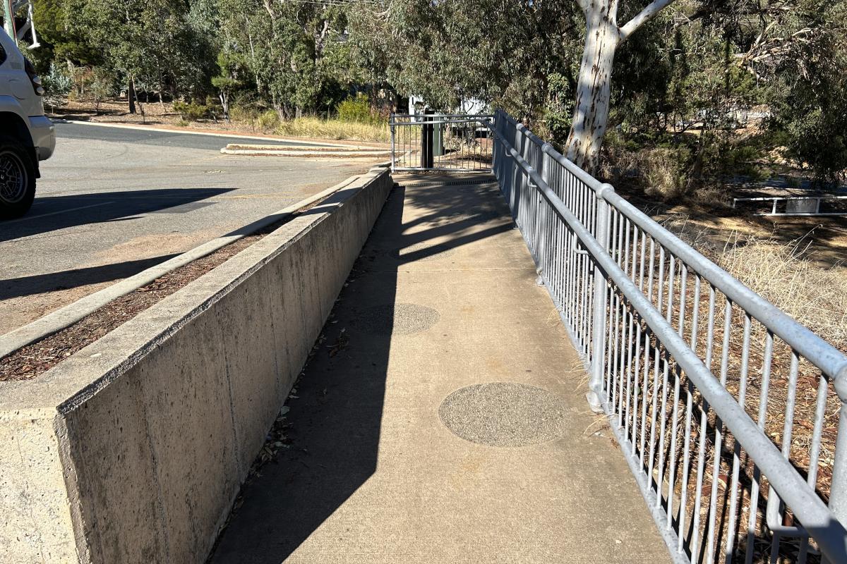 Lesmurdie Falls Path with railings on one side and limestone wall on the other.