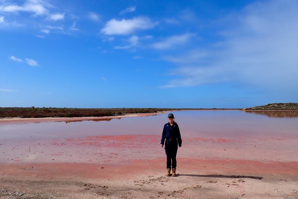 Person standing near a body of water.