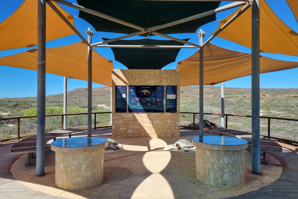 Shaded area with limestone all and information panels. 