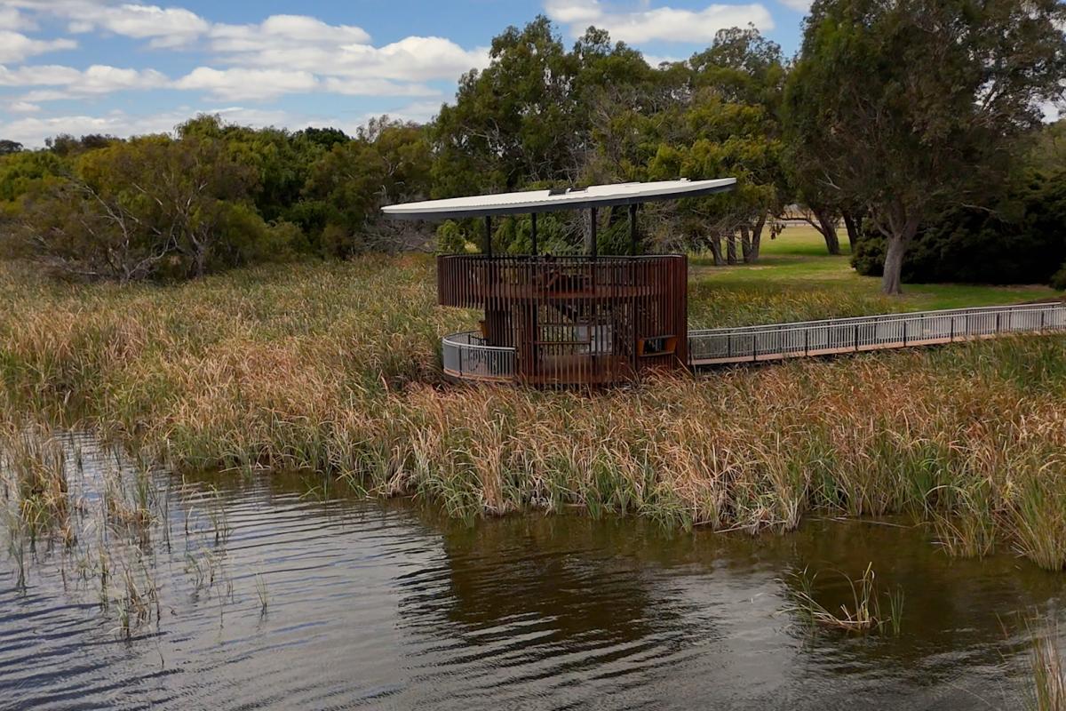 Bird watching tower next to a lake. 