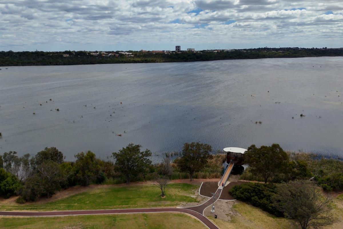 Aerial view of bird watching tower next to a lake. 