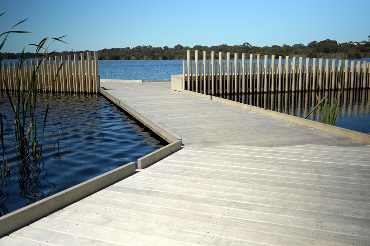 Board walk leading out of a lake. 