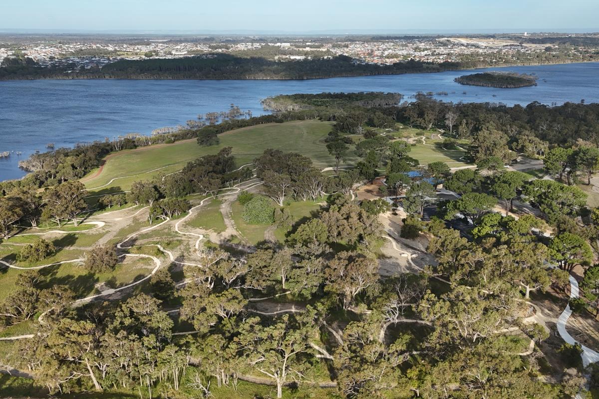 Aerial view of trails next to a lake. 