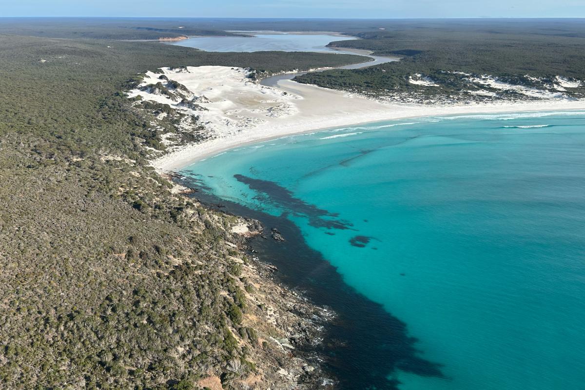 View of a bay with sandy beaches and clean blue water and a river leading away.